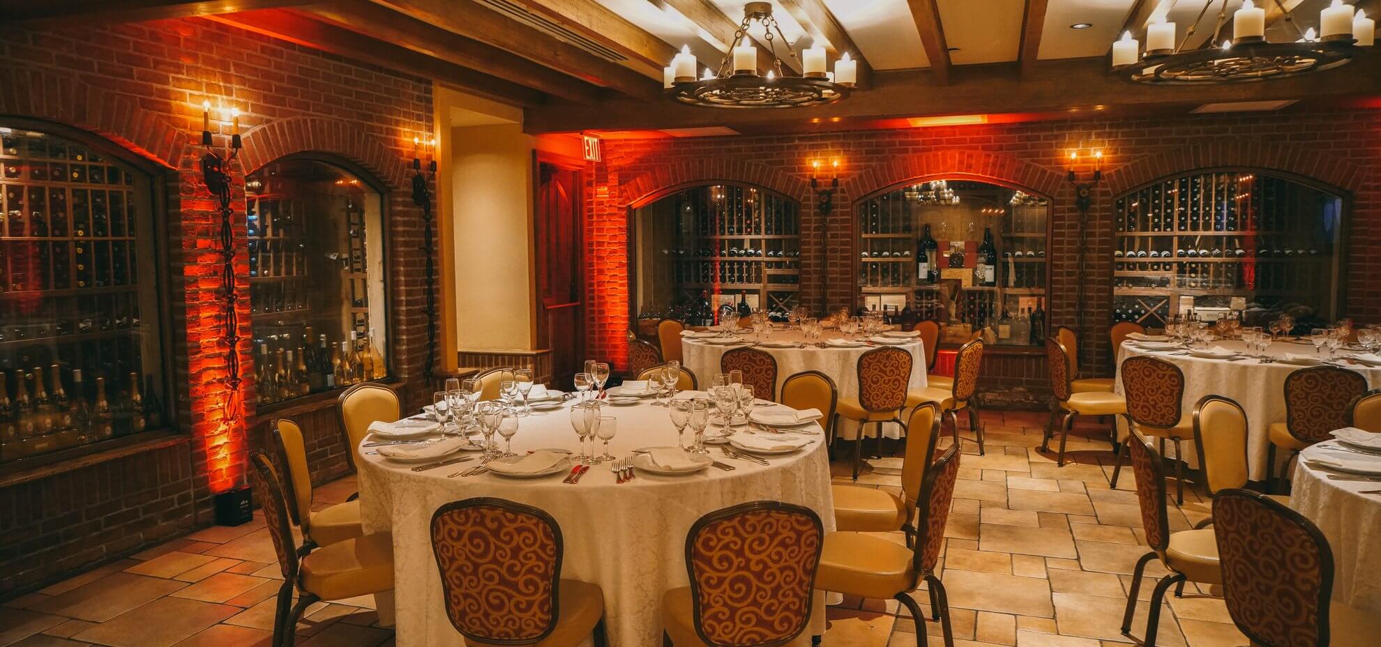 The Wine Cellar with amber uplighting and round tables