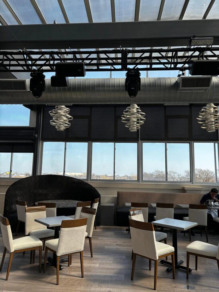 Rooftop booth beside the windows overlooking the water