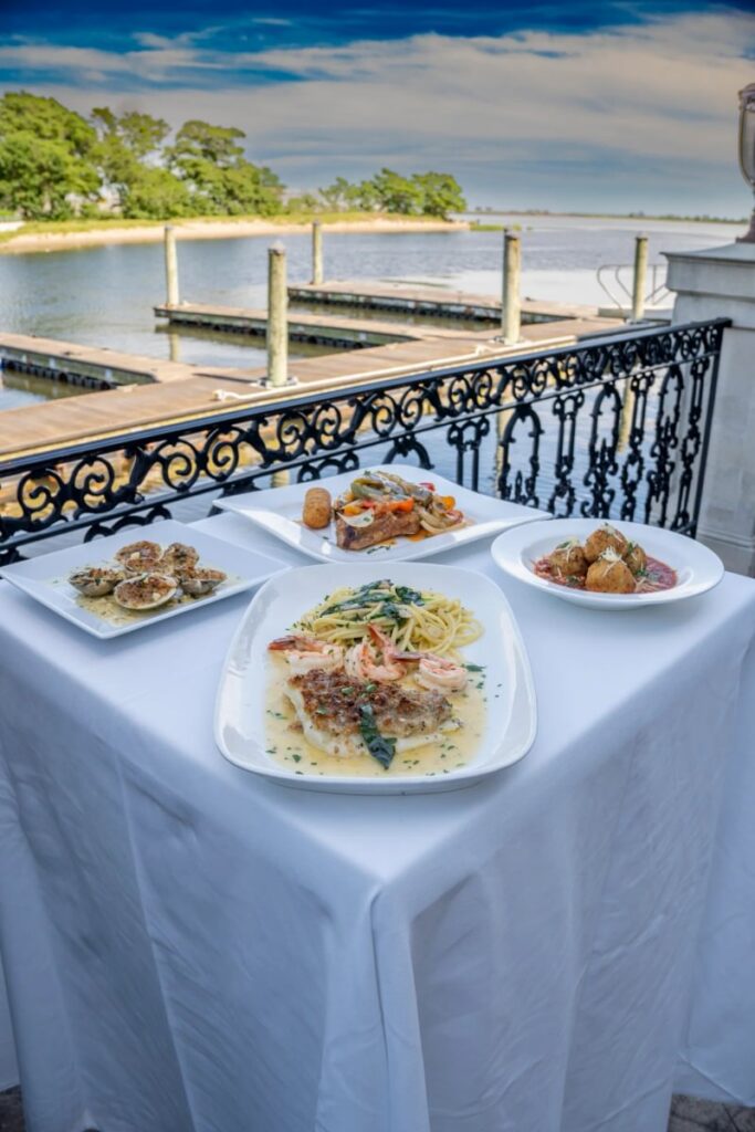 Plated dishes served outdoors on Vetro’s waterfront veranda