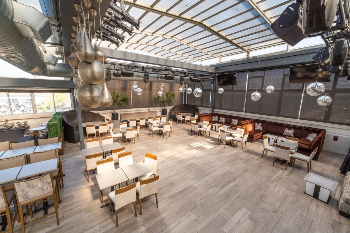 Vetro Rooftop Lounge with tables beneath its glass roof