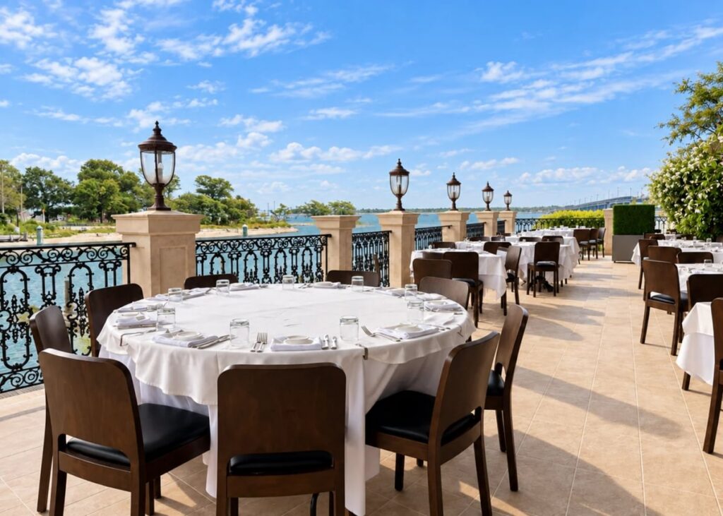 Tables set along the Waterfront Veranda with Jamaica Bay beyond