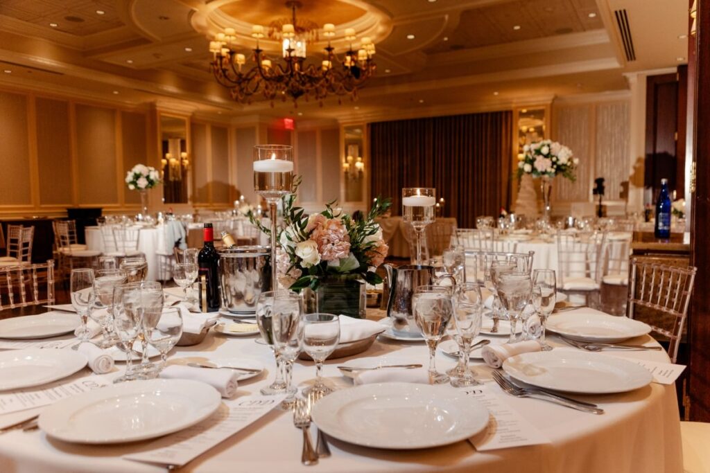 Round tables set for a wedding reception in the Murano Room